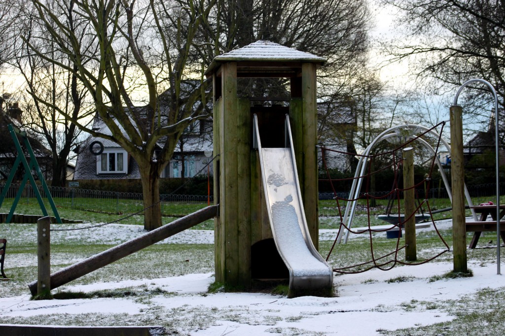Children's slide covered with snow